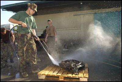 Timor, New Zealand
Defence Force: Private Ray Meki water blasts is pack before
coming home
