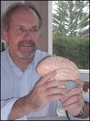 Dr Robert Isler
holding a model of the human brain. Photo credit: Sophie
Isler.