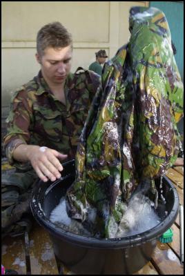 Timor, New Zealand
Defence Force: Private Chris Sinclair cleans his equipment
to tough MAF standards