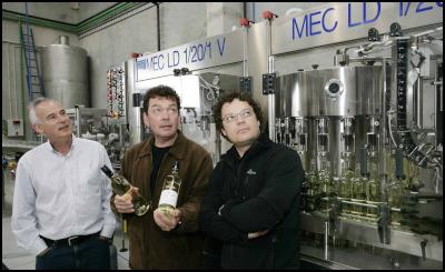 L-R - Jim Veitch, 
Theo Giesen (without glasses) ,  Marcel Giesen   at the
company's  recently  opened bottling
plant.