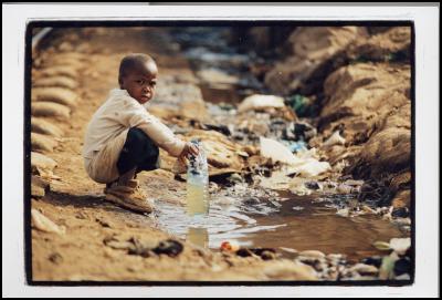 A child collecting
drinking water from a water source in a slum in Kenya.
Source: Phill Prendeville