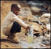 A child
collecting drinking water from a water source in a slum in
Kenya. Source: Phill Prendeville