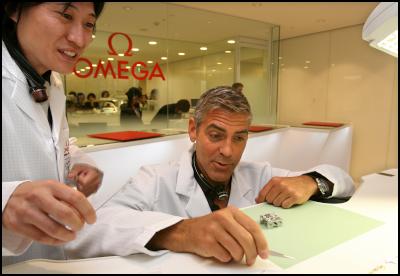 George Clooney (R)
assembles an Omega watch