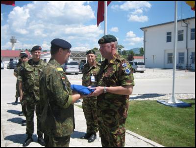 Commander of the
European Union Forces (EUFOR) Rear Admiral Hans-Jochen
Witthauer hands the New Zealand flag to Major Michael
Brown.