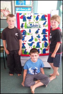 Students Jordan
Robinson, Matt Peel and Connor Close pose with their takahe
quilt 