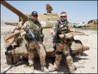 Major Simon
Strombom (L) and colleague Petty Officer Seaman Combat
Specialist (POSCS) Nicholas Hunter Royal New Zealand Navy
next to discarded Russian tanks in Afghanistan, 2008. (NZDF
Official)