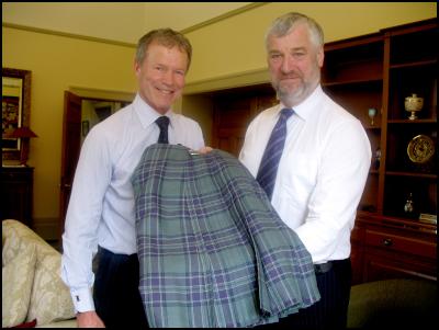 The Speaker of the
House of Representatives, the Hon Dr Lockwood Smith, is
pictured left, being presented with a kilt in the tartan of
the Scottish National Parliament by the Presiding Officer,
Alex Fergusson.