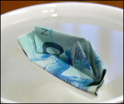 floating currency
– new zealand ten dollar bill as origami boat