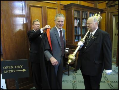 The Speaker of the
House, Dr The Rt Hon Lockwood Smith, centre, dons his
Speaker’s robe with the help of Speaker’s Assistant,
Roland Todd, left, with the Serjeant –at-Arms, Brent
Smith. The Speaker’s office will be opened to the public
for the Parliament Open Day on Sunday 7
November.