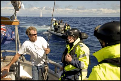 Tuesday, April 12,
2011. Police warn Avon Hansford, skipper of Windborne, about
approaching within set distances of the oil survey ship
Orient Explorer after the flotilla opposing deep sea oil
drilling stopped seismic surveying on Sunday.