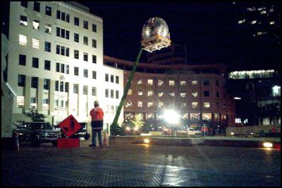 Fern sculpture ('Fernball') being
held by a crane as it is taken down for repairs in Civic
Square, Wellington