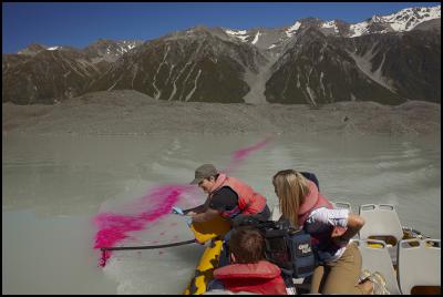 Fine arts student
Amelia Hitchcock uses a special rig to distribute dye into
the lake from a Glacier Explorers boat.  Please credit Mike
Langford