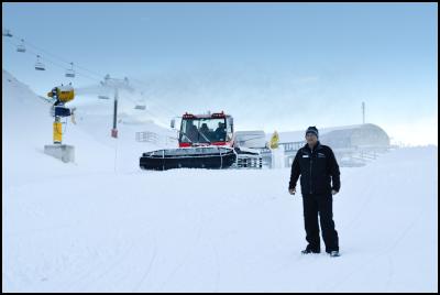 Coronet Peak Ski
Area Manager Hamish McCrostie pictured with a snow gun
blazing and groomer operating in preparation for opening
this Saturday (June 9). 