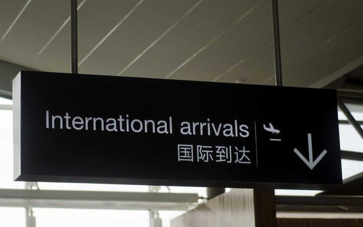 an international
arrivals sign at an airport