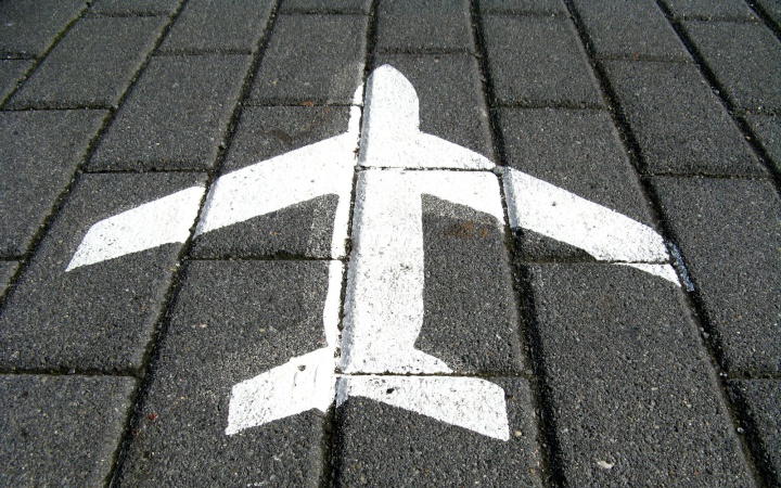 an airplane icon painted on paving bricks