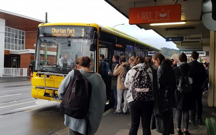 Commuters at a bus
stop in Newtown this morning Photo: RNZ / Emma Hatton