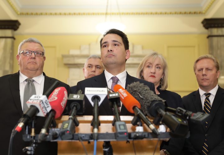 Simon Bridges
(centre) speaking to media about the leak of a text from the
person behind an earlier leak on his expense spending.
Photo: RNZ / Rebekah Parsons-King
