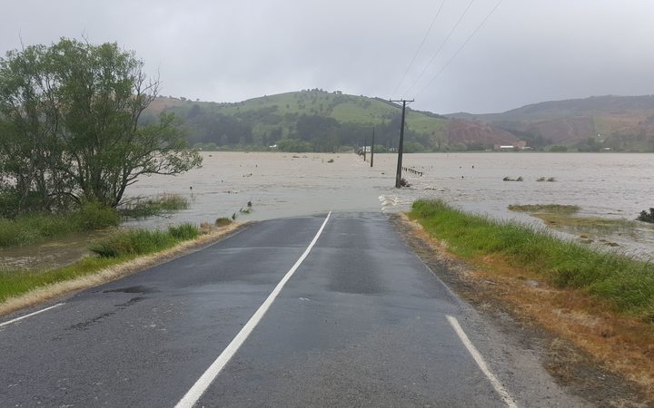 a road disappearing
into floodwater