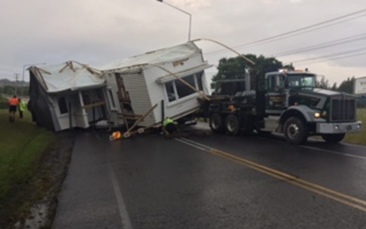 A house has fallen
off a transporter on State Highway 16. Photo: NZ Police 