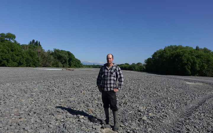 Ongaonga farmer
Alistair Setter stands in the middle of the dry Waipawa
River bed. Photo: RNZ / Anusha Bradley 