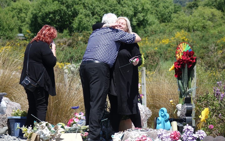 Sonya Rockhouse
receives a hug from Bernie Monk at Atarau, a memorial site
near the Pike River Mine.