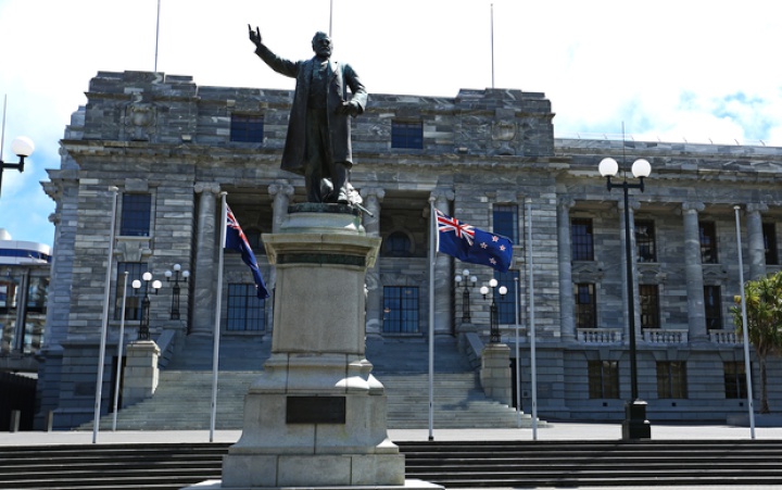 the outside of
Parliament building with a statue