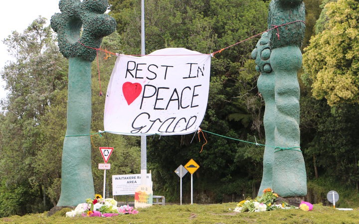 banner suspended
between roadside sculptures: Rest in Peace Grace, with
bunches of flowers left at the base