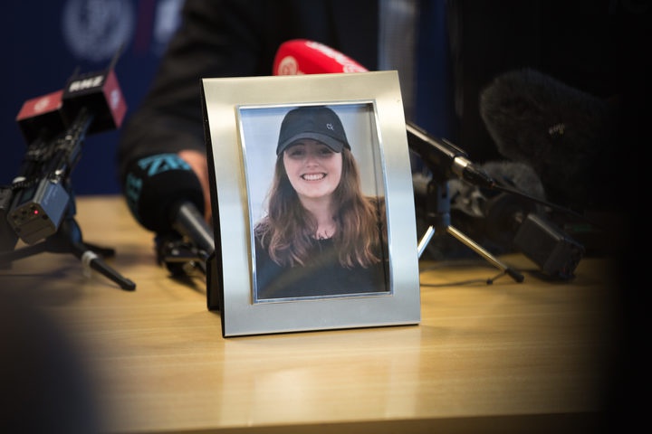 framed photo of
Grace Millane on a press conference table