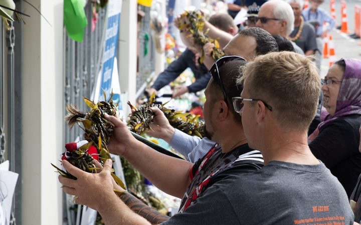 people placing the
lei on a fence