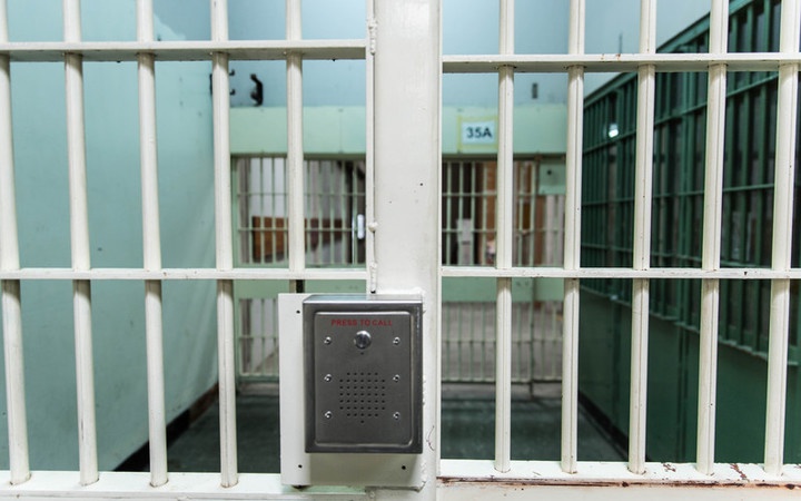 a view through
steel gate doors inside a prison