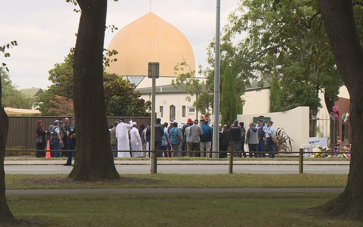 a group of people
outside the gates of Al Noor mosque