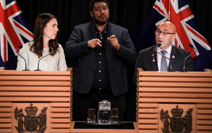 ardern and mark at
the beehive press conference, with sign language translator