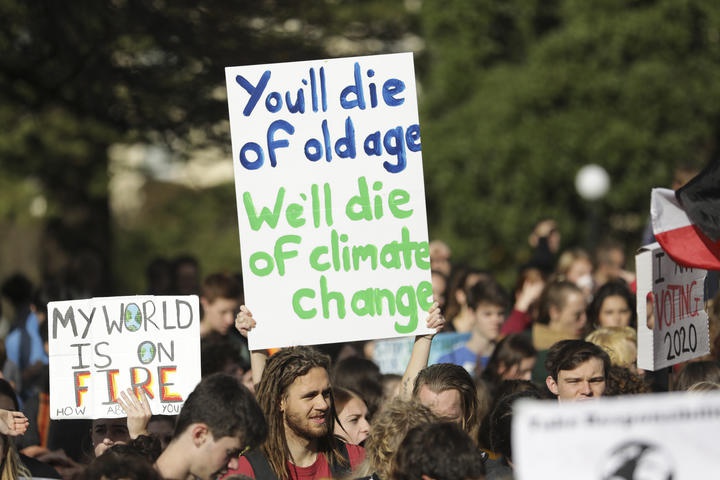 young people
protesting climate inaction. Largest placard reads 'You'll
die of old age / We'll die of climate change