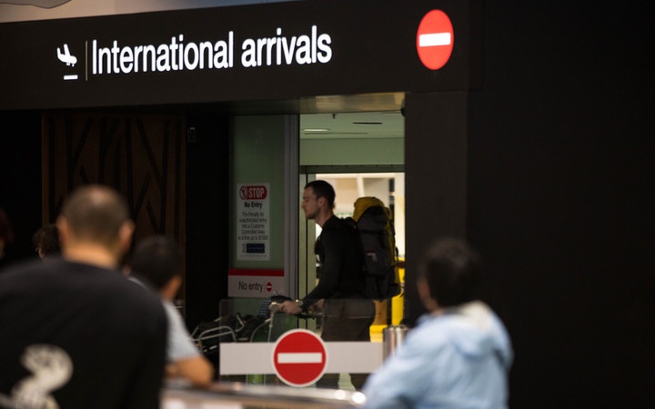 a person coming out
the international arrivals door at an airport