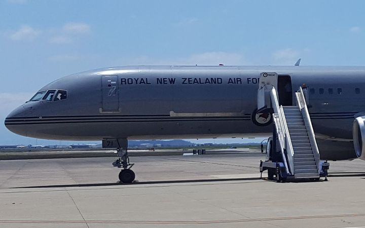 a 757 with 'royal
new Zealand air force' written on the side, at an airport
with the door open and stairs attached