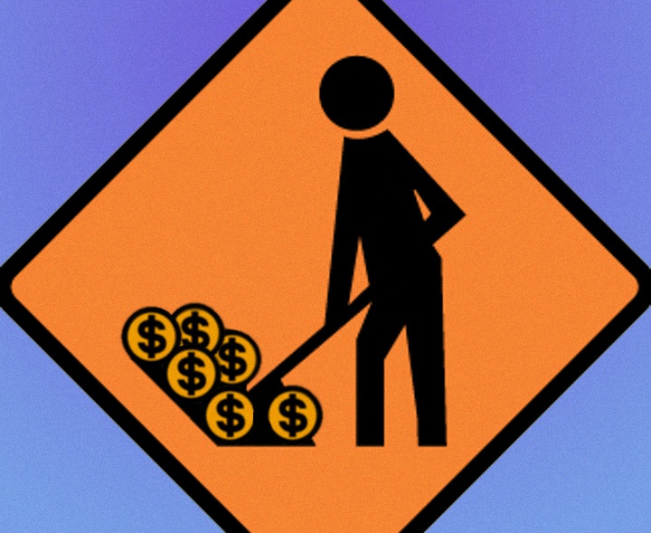 a road works sign
but the figure is shoveling money