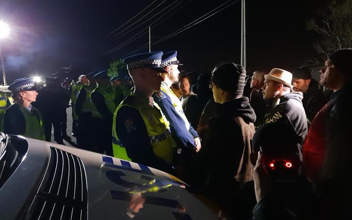 protestors standing
face to face with the police line