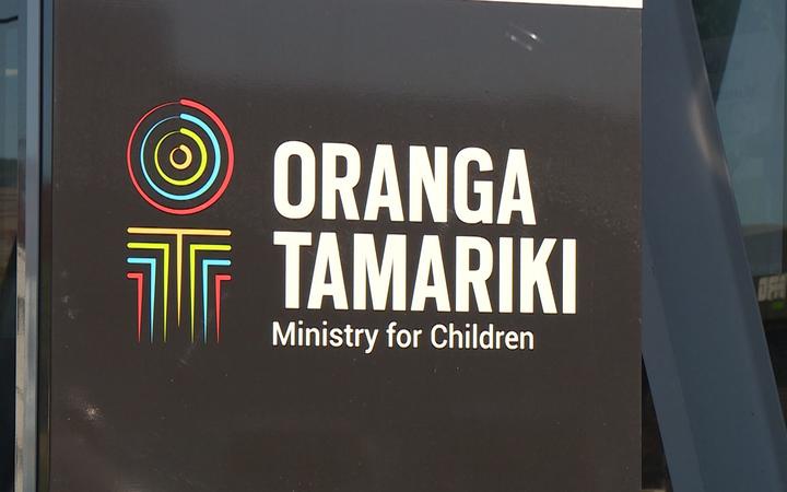 a sign with the
logo for orange tamariki / ministry for children