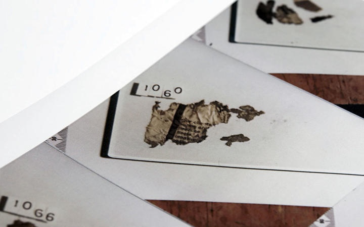 scortched newspaper
fragments attached to evidence sheets with numbers