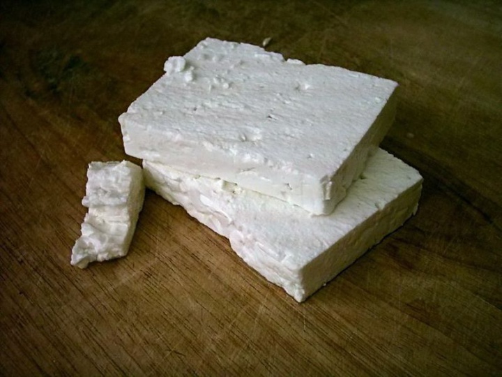 wide blocks of feta
cheese on a wooden surface