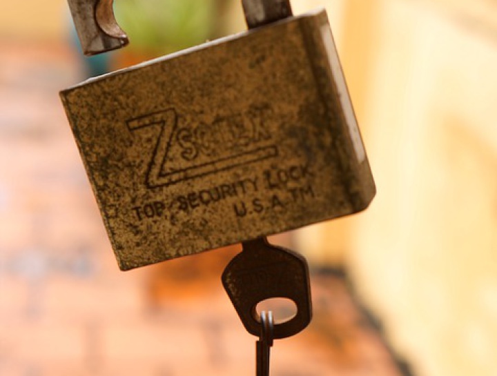 a rusty open
padlock with the key left in it