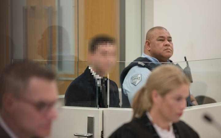 a man in court,
with his face pixellated