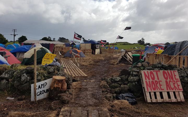 campground at the
protest site, with thents, placards and flags 