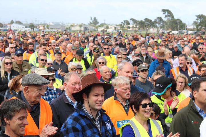 a large crowd, many
in fluro vests